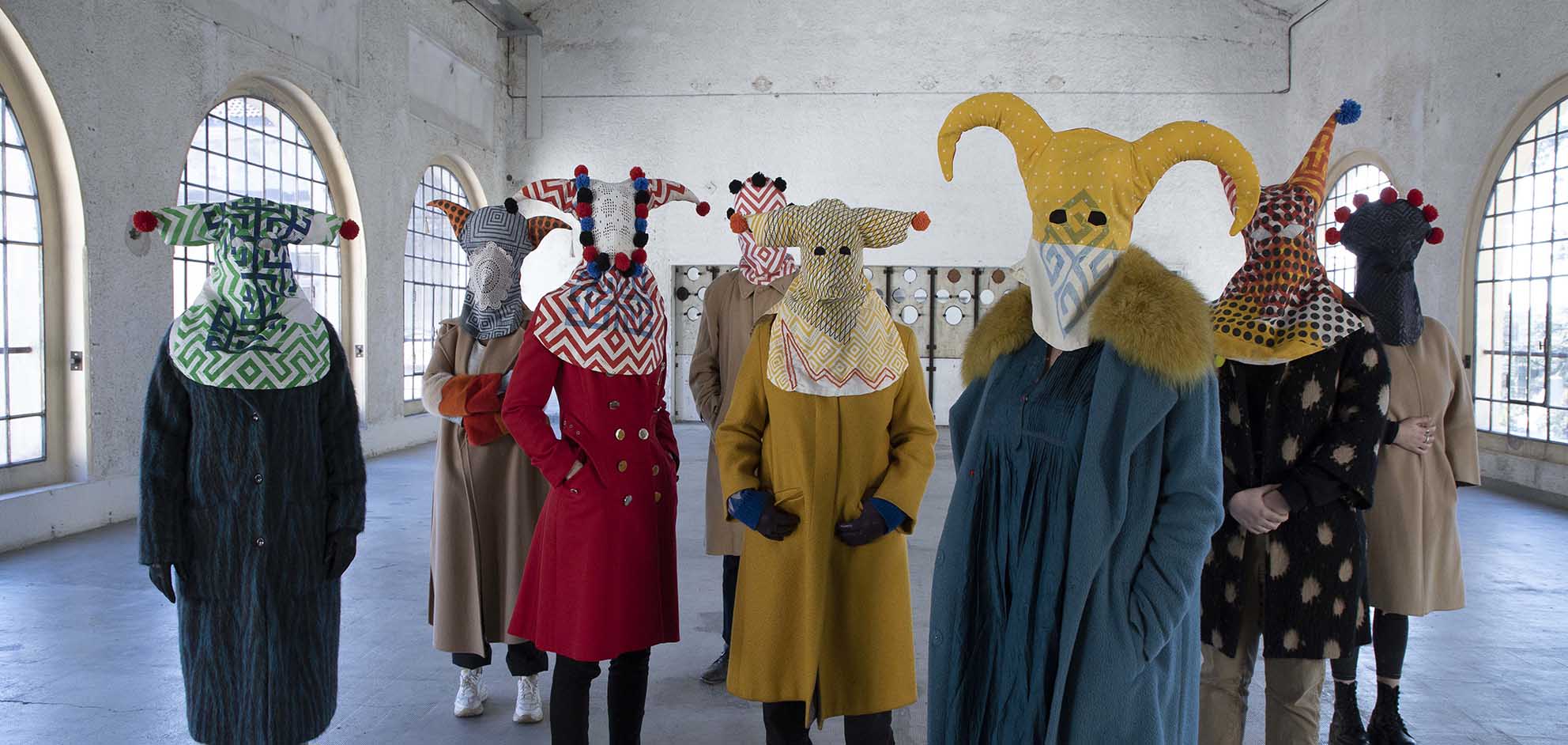 masked people with handprinted and handsewn mask